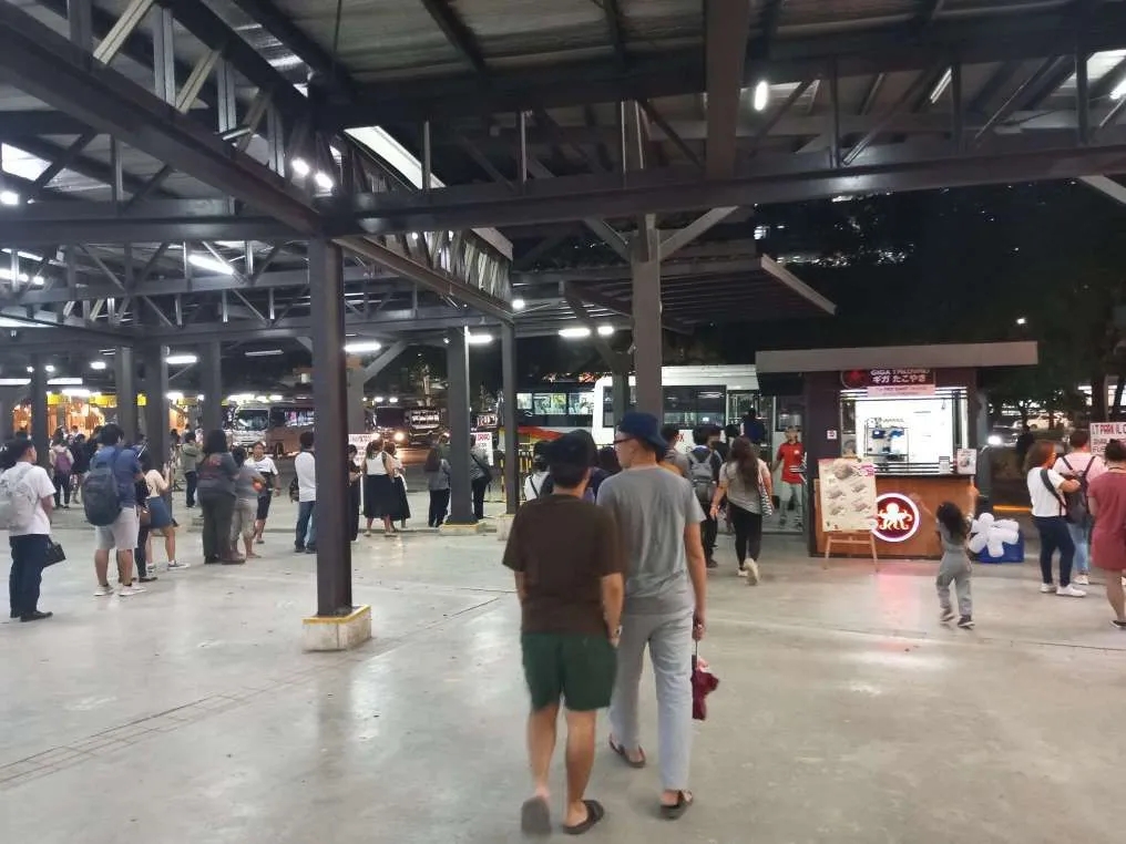Lots of Cebuanos lining up to ride a bus home in the Cebu IT Park Transport Terminal at night. It's a mix of people between students and employees.