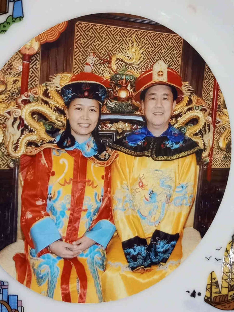 Filipino Asian couple was in Hongkong wearing traditional Chinese garments for a souvenir photoshoot.